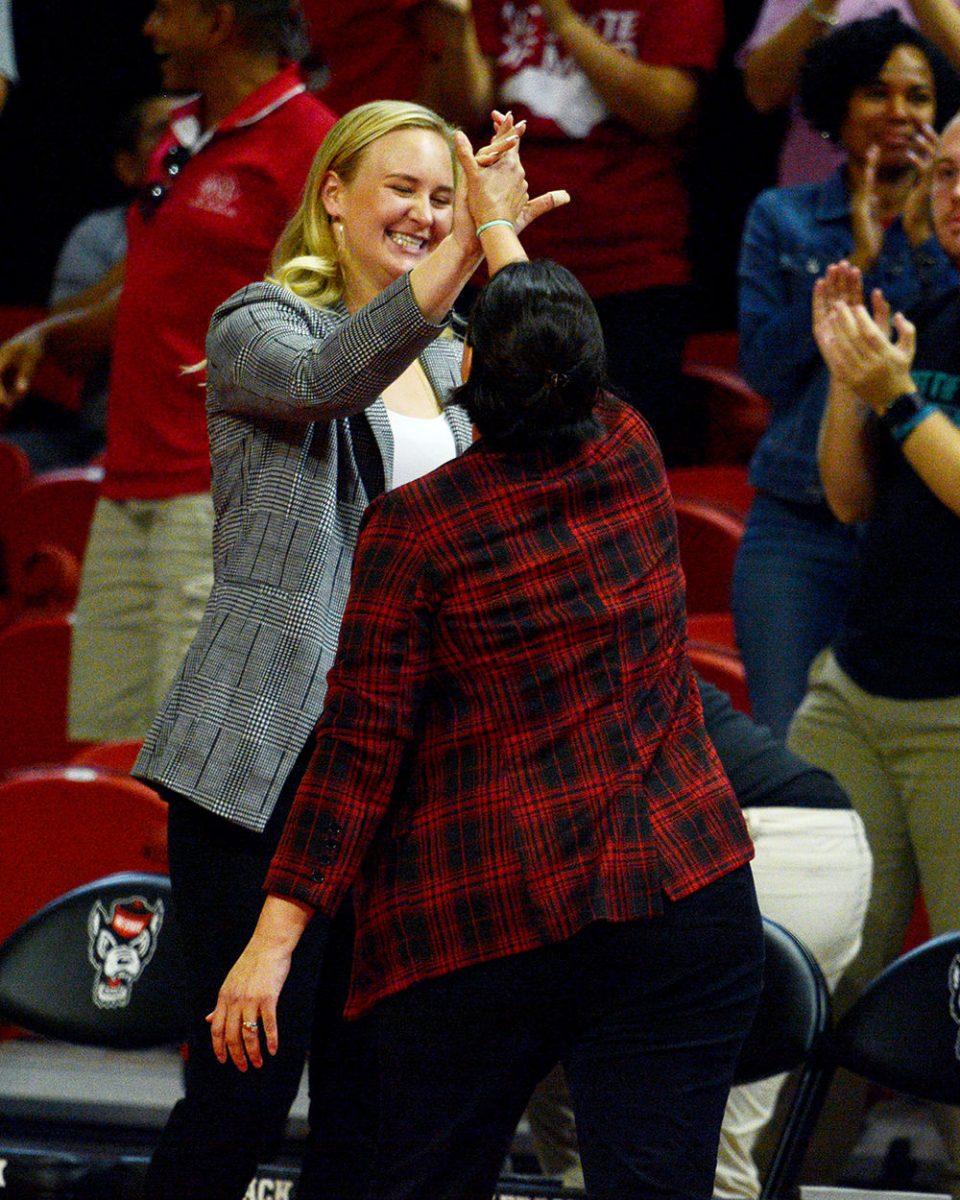 Coach Linda Hampton-Keith gives a high five to former NC State volleyball alumnus, and coach Julia Brown after the Wolfpack&#8217;s 3-2 victory over Virginia Tech on October 4 in Reynolds Coliseum.