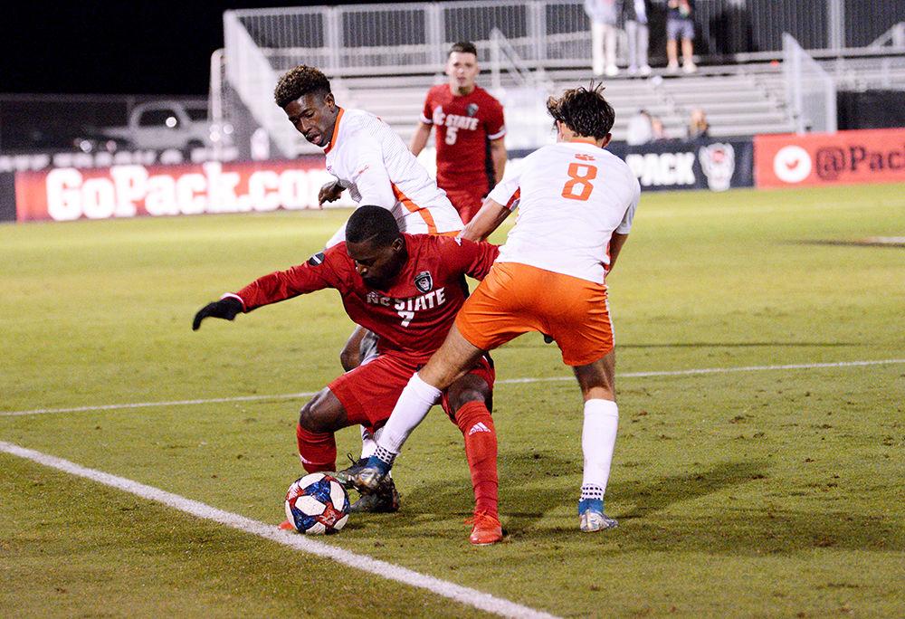 Sophomore forward Ivy Brisma fights for the ball against two Clemson players. During the game Brisma attempted three shots, two of which were on goal. The Wolfpack lost 0-3 against Clemson on Friday, Nov. 1, 2019 at Dail Soccer Field.