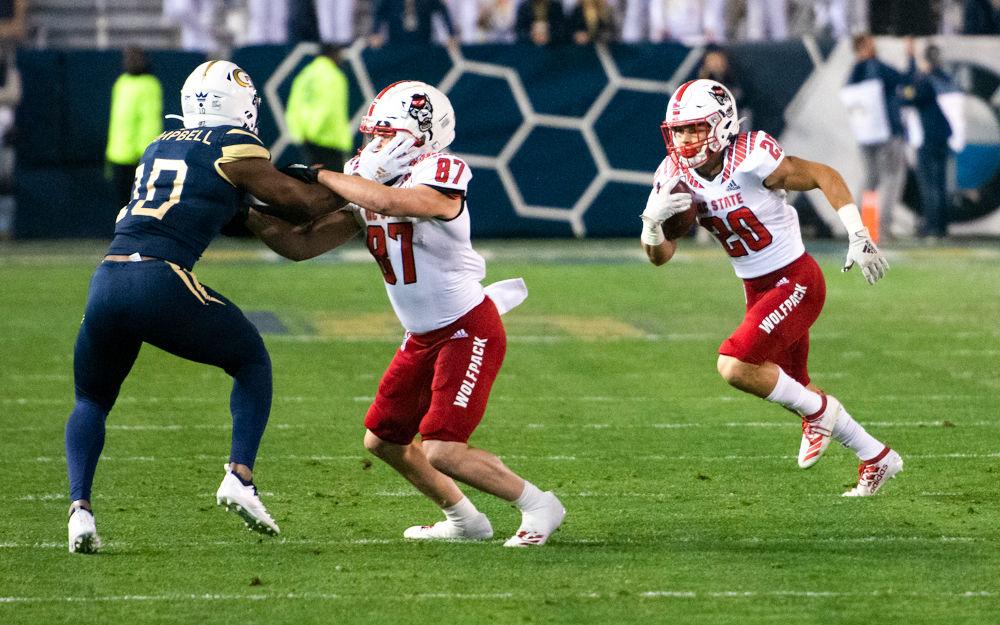 Freshman running back Jordan Houston runs behind redshirt sophomore wide receiver Thayer Thomas's block during NC State's game against Georgia Tech at Bobby Dodd Stadium on Nov. 21, 2019. The Wolfpack lost 28-26.