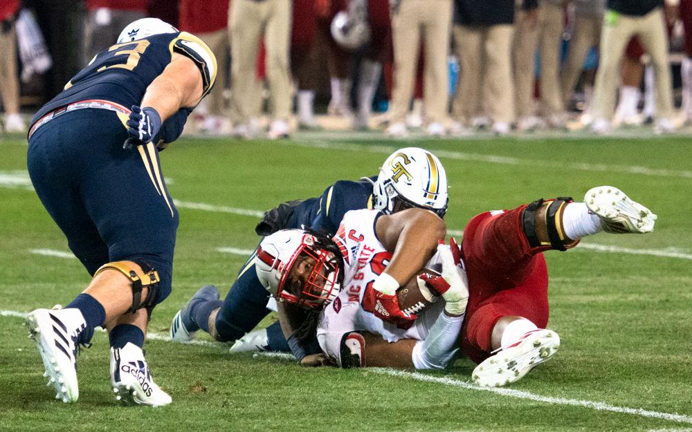 NC State graduate defensive tackle Larrell Murchison recovers a fumble during NC State's game against Georgia Tech at Bobby Dodd Stadium on Nov. 22, 2019. The Wolfpack lost, 28-26.