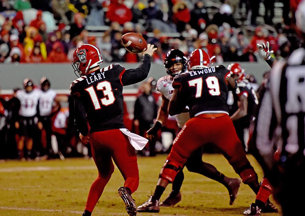 Redshirt freshman quarterback Devin Leary fumbles the ball while throwing a pass against Louisville at Carter-Finley Stadium on Saturday, Nov. 16, 2019. NC State lost to Louisville 34-20.