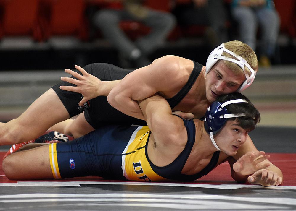 Graduate Hayden Hidlay in the 157-pound weight class, pins down his opponent during a dual against Drexel on Saturday, Jan. 19 at Reynolds Coliseum. The Wolfpack beat the Dragons 25-16.