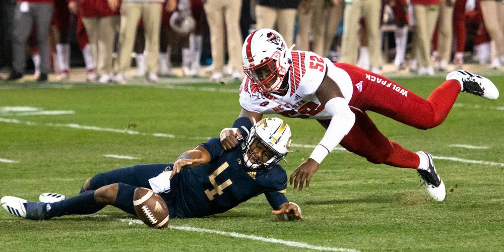 Redshirt sophomore defensive end Ibrahim Kante holds James Graham back after forcing a fumble during NC State's game against Georgia Tech at Bobby Dodd Stadium on Nov. 21, 2019. The Wolfpack lost 28-26.