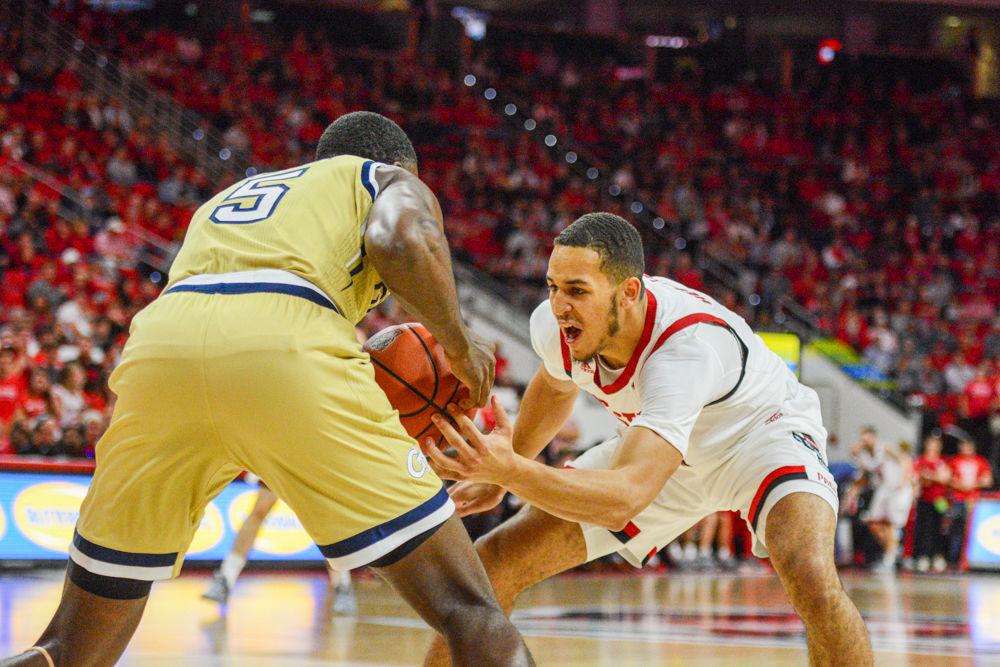 Sophomore forward, Jericole Hellems attempts to tie the ball in PNC Arena on November 5. Hellems played 32 minutes and scored 15 points, had four rebounds, and two assists in the Wolfpack&#8217;s 82-81 overtime loss to Georgia Tech.