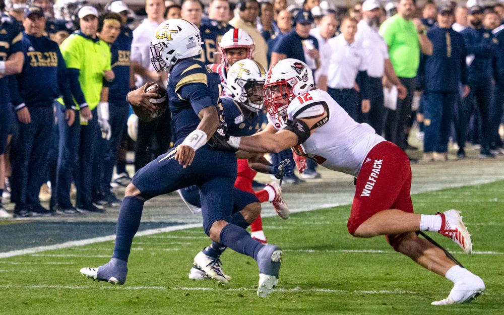 Redshirt junior linebacker Brock Miller attempts to tackle quarterback James Graham during NC State's game against Georgia Tech at Bobby Dodd Stadium on Nov. 21, 2019. The Wolfpack lost 28-26.