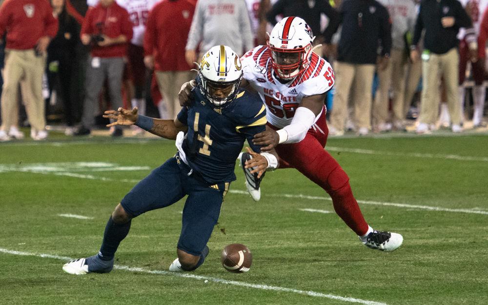 NC State redshirt sophomore defensive end Ibrahim Kante forces a fumble during NC State's game against Georgia Tech at Bobby Dodd Stadium on Nov. 22, 2019. The Wolfpack lost, 28-26.
