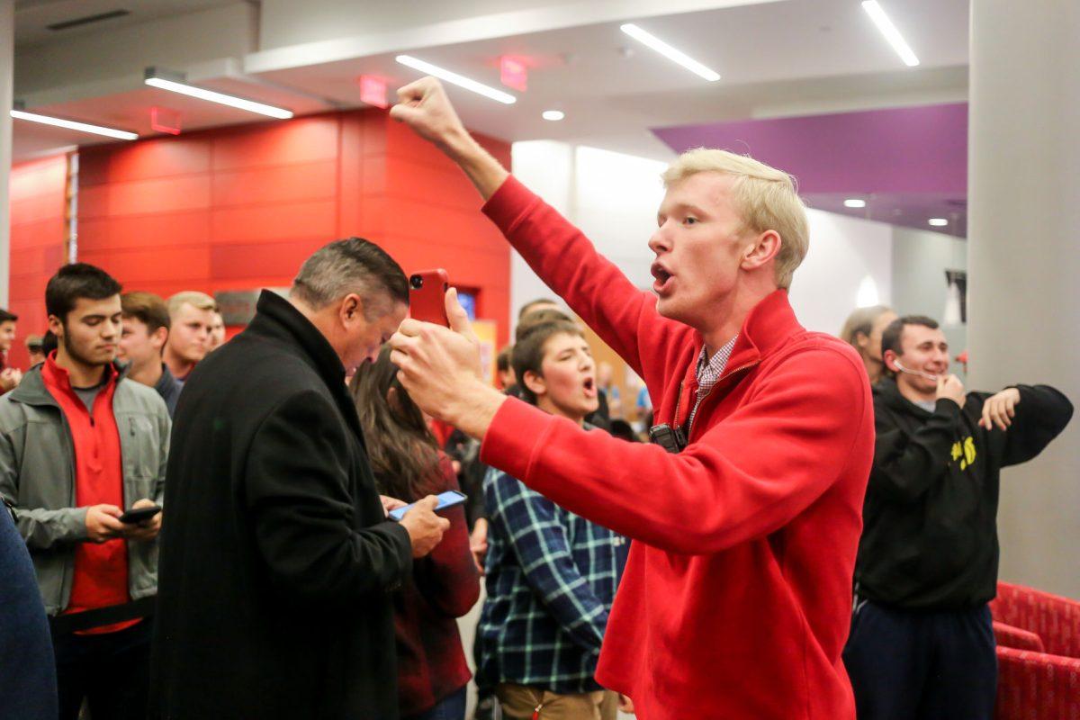 Luke Stancil, a senior studying Agricultural Business Management, leads a "U-S-A" chant to counter protester chants, while broadcasting the event on Facebook Live, at a Turning Point "Culture Wars" event in Talley Student Center on Wednesday, Nov. 13, 2019.