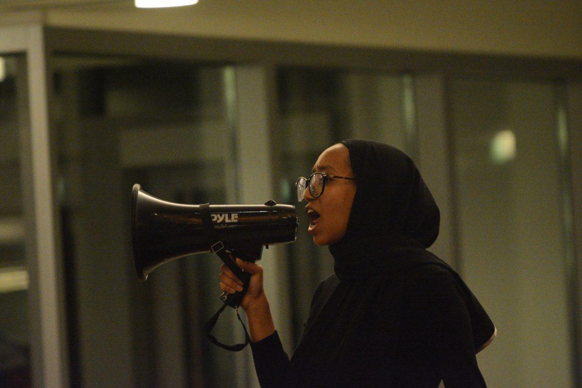 Hanadi Ibrahim, a third-year majoring in textile technology and Platform model posing, leads some of the chants during the No Hate at NC State Protest on Wednesday, Nov. 13, 2019. The No Hate at NC State protest was protesting the Turning Point U.S.A. Culture War event.