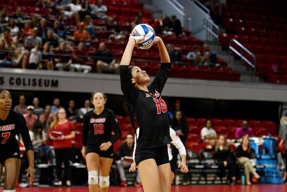 Redshirt freshman setter Nina Sharpton sets the ball against Virginia Tech on October 4 in Reynolds Coliseum. Sharpton played in five sets with 31 assists, 18 digs, and one block in the 3-2 win against Virginia Tech.