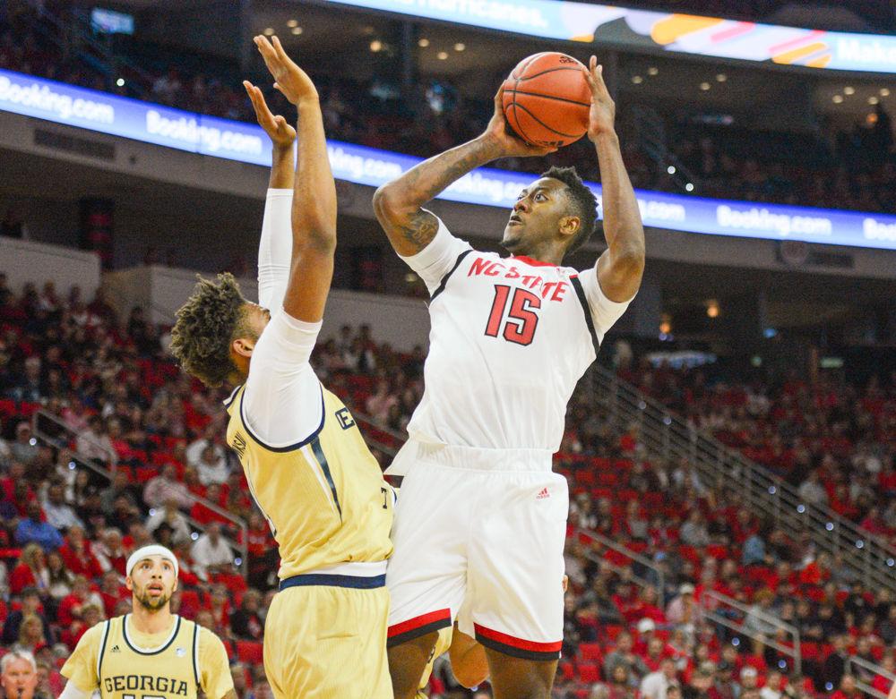 Redshirt freshman forward, Manny Bates shoots the ball over a Georgia Tech defender in PNC Arena on November 5, 2019. Bates played 33 minutes, scored two points, and had seven rebounds and five blocks in the Wolfpack&#8217;s 82-81 overtime loss to Georgia Tech.