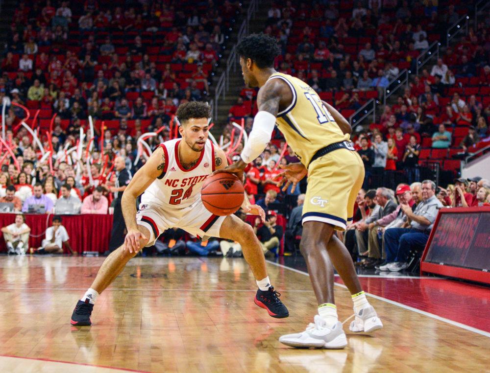 Redshirt junior guard, Devon Daniels guards a Georgia Tech defender in PNC Arena on November 5, 2019. Daniels played in 34 minutes and scored 12 points, had three steals, five assists and three rebounds in the Wolfpacks 82-81 overtime loss to Georgia Tech.
