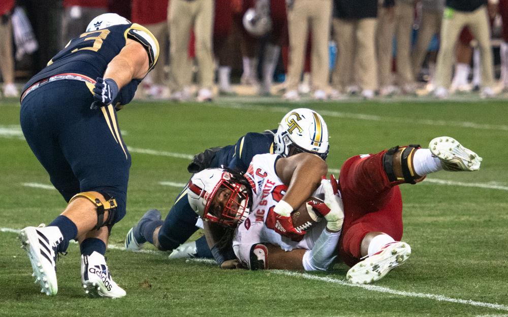 NC State graduate defensive tackle Larrell Murchison recovers a fumble during NC State's game against Georgia Tech at Bobby Dodd Stadium on Nov. 22, 2019. The Wolfpack lost, 28-26.