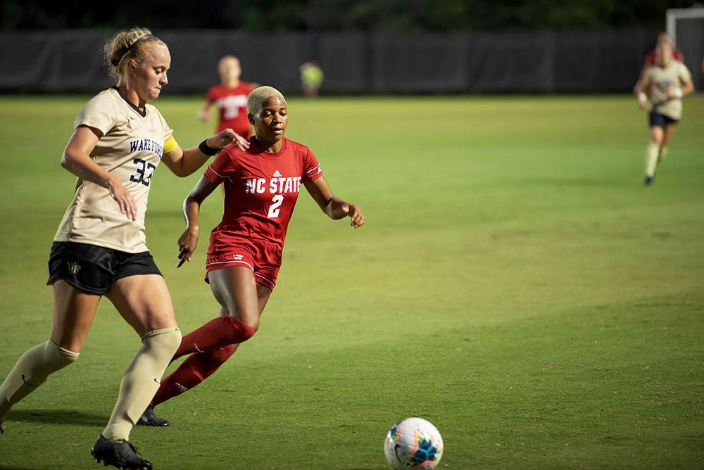 Senior midfielder Tziarra King attacks the ball while being chased down by a Wake Forest defender during the NC State Women's Soccer Match versus Wake Forest at W. Dennie Spry Soccer Stadium on Sunday, Sept. 29, 2019. King finished with one goal in a match that saw Wake Forest and NC State tie 1-1.