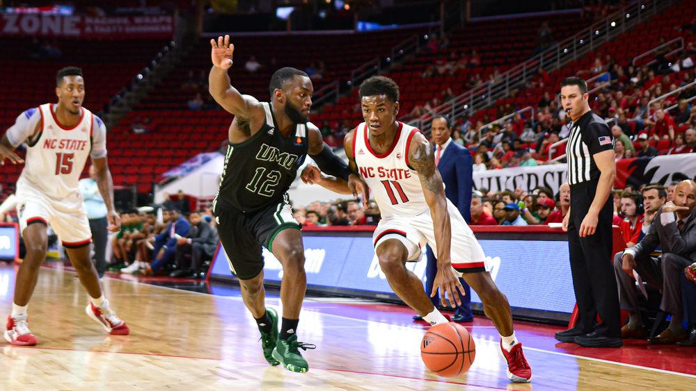 Senior guard Markell Johnson dribbles against Mount Olive guard Cameron Robinson on Sunday, Oct. 27, 2019 at PNC Arena. Johnson scored a game-high 26 points in addition to nine assists and six steals. The Wolfpack won 113-73.