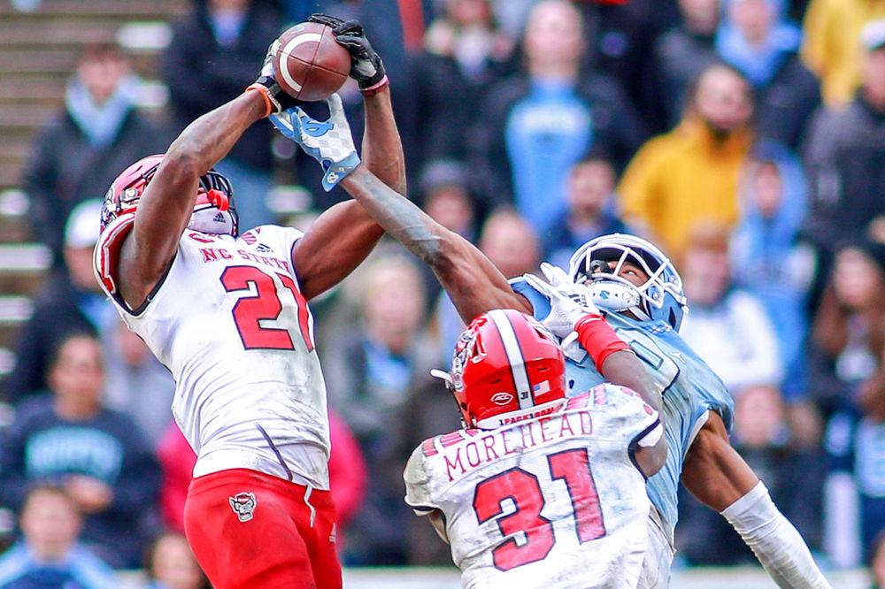 Redshirt junior nickelback Stephen Griffin attempts an interception, but is unable to complete the catch. The Wolfpack was tested by the Tar Heels, but came away with a 34-28 overtime win on Saturday, Nov. 24 in Kenan Memorial Stadium.