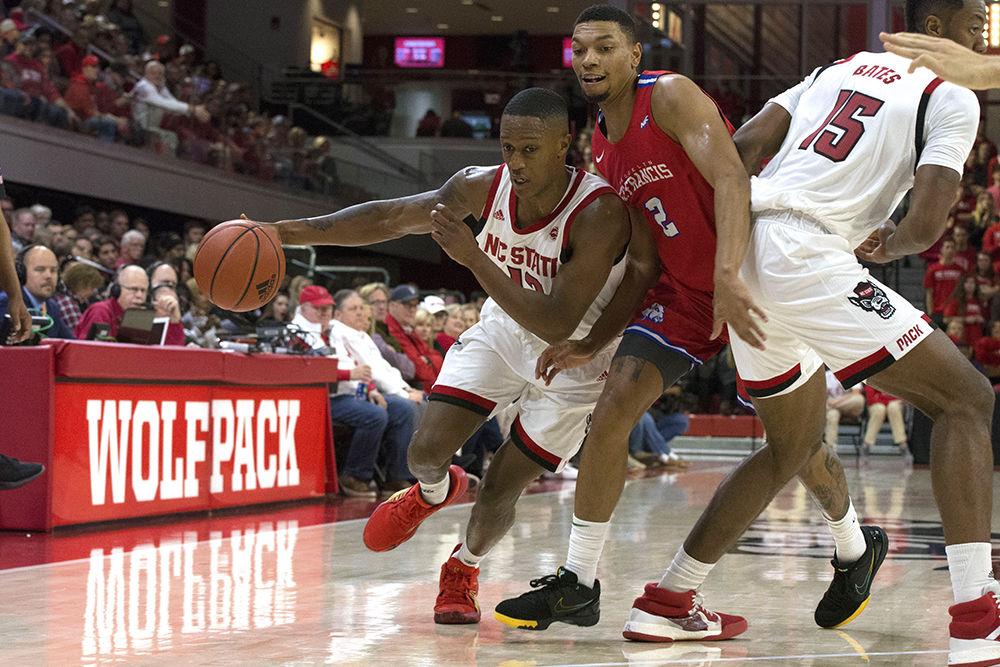 Redshirt senior guard C.J. Bryce drives past a member of the St. Francis College team for a layup during the first Heritage game of the season in Reynolds Coliseum. The Pack took down the Terriers, 95-64.