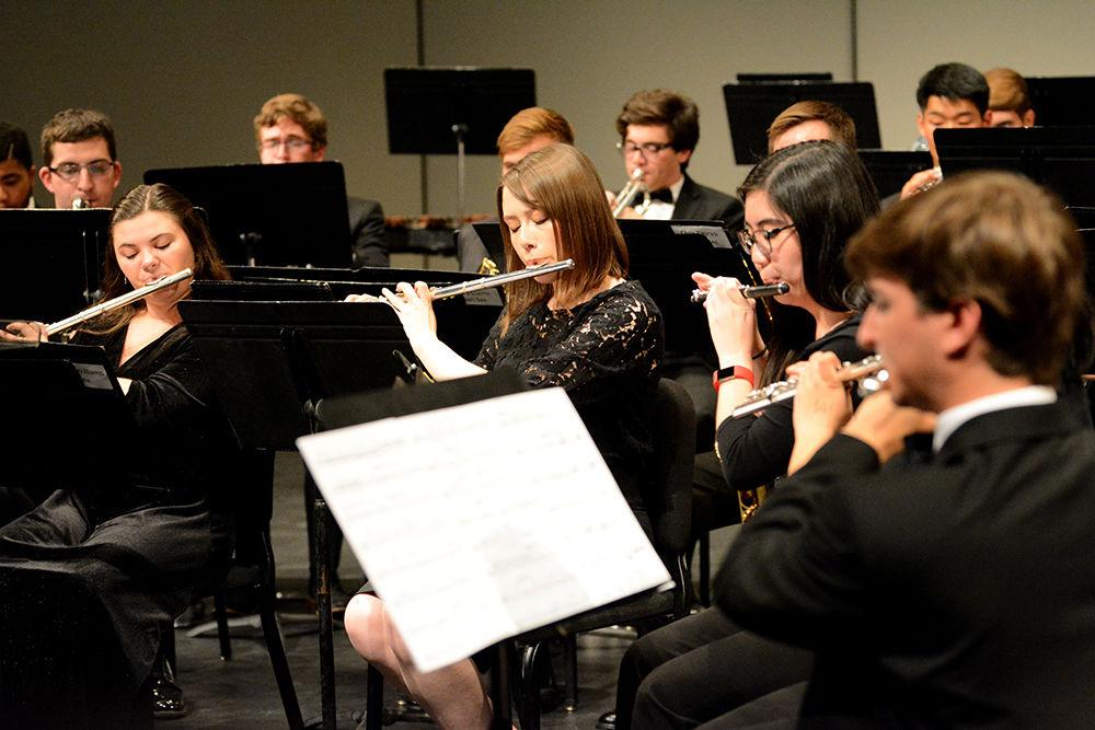 Several flute players take the lead on the song on Tuesday, Nov. 5, 2019. Wind Ensemble includes different instruments such as piccolos, oboes, flutes, English and French horns, bassoons, tubas, clarinets. saxophones, trumpets, euphoniums, and several percussion instruments.