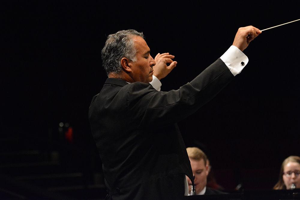 The conductor guides the ensemble through the music on Tuesday, Nov. 5, 2019. Wind Ensemble includes different instruments such as piccolos, oboes, flutes, English and French horns, bassoons, tubas, clarinets. saxophones, trumpets, euphoniums, and several percussion instruments.