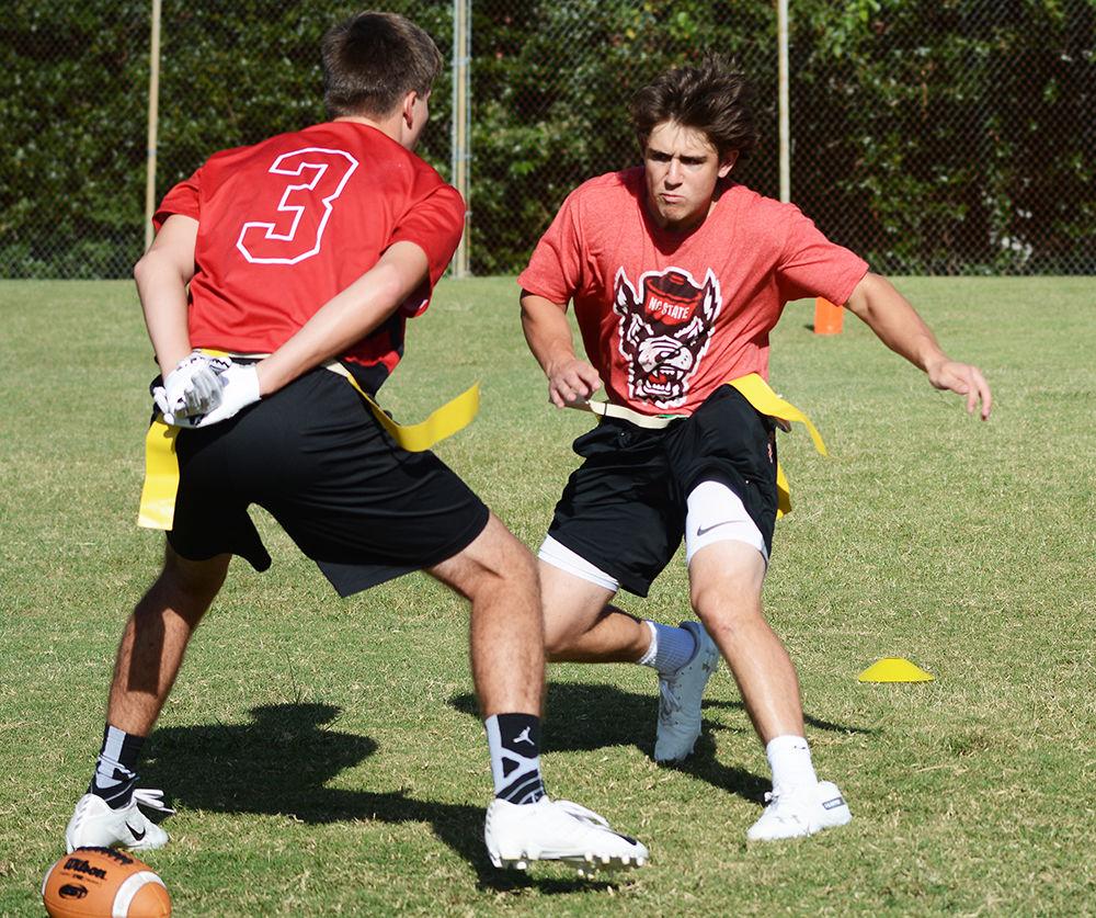 First year studying meteorology Cory Kowitz goes for the ball against second year studying sports management Trey Utrup during a club flag football practice on Friday, Sep. 20, 2019 at Lee Field . NC State's club flag football team recently completed tryouts and has begun preparing for upcoming games.