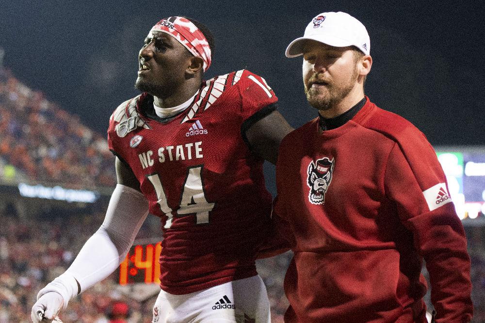 Sophomore safety De'Von Graves is led off the field after sustaining an injury during the Homecoming football game against Clemson in Carter-Finley Stadium, Sat. Nov. 9, 2019.&#160;