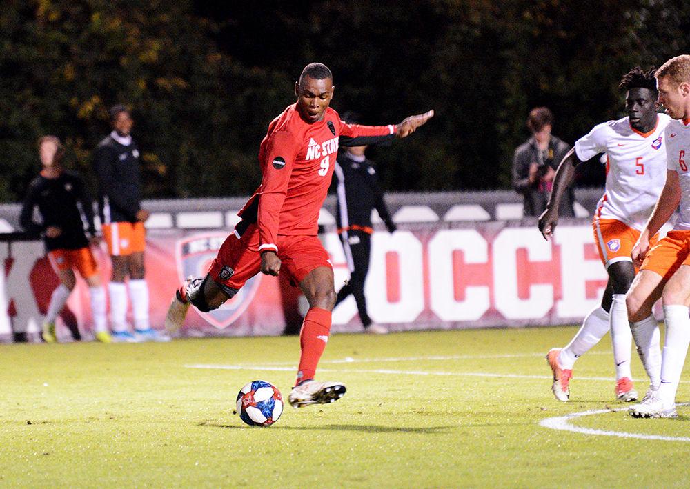 Sophomore forward Kuda Muskwe passes the ball to a teammate. Muskwe attempted four shots throughout the game on Friday night. NC State lost to Clemson 3-0 on Nov. 1, 2019 at Dail Soccer Field.