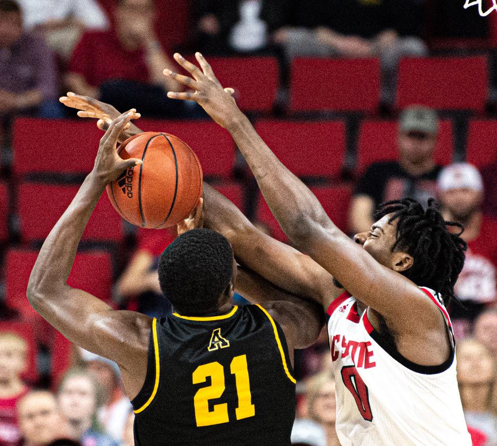 Redshirt junior forward D.J. Funderburk blocks a shot by Appalachian State forward James Lewis Jr. on Sunday, Dec. 29, 2019 at PNC Arena. Funderburk recorded 22 points and nine rebounds as the Wolfpack won 72-60.