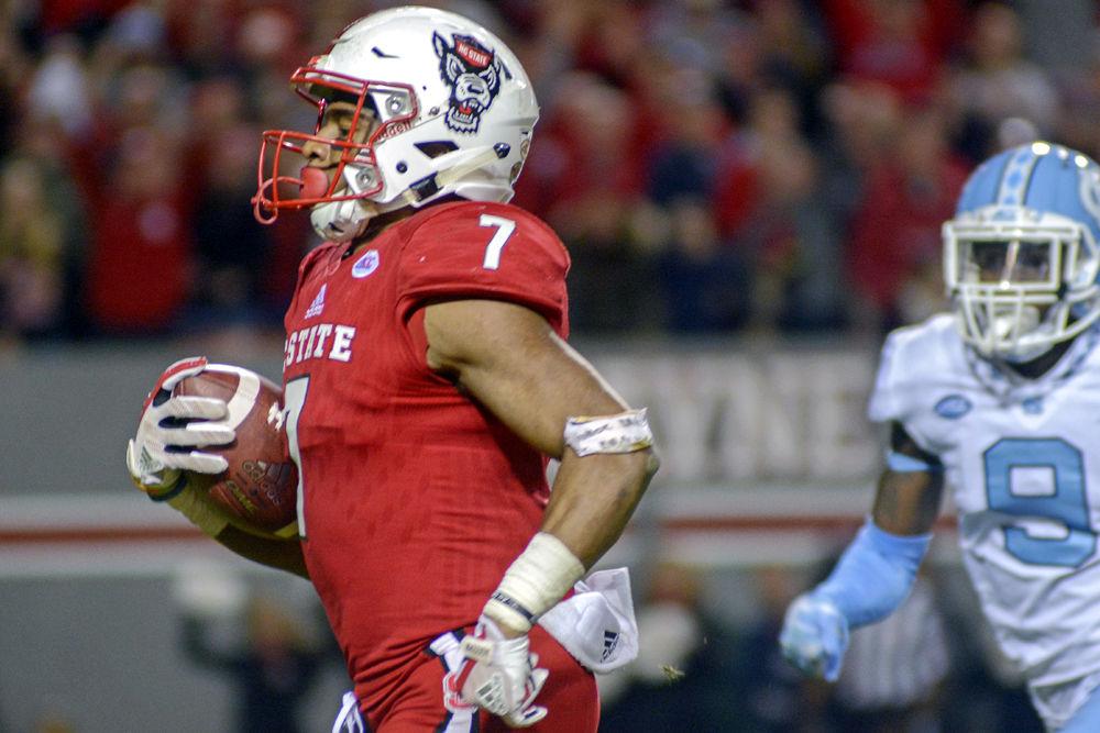 Junior running back Nyheim Hines sprints to the end zone on Nov. 25, 2017 at Carter-Finley Stadium. Hines finished the game with 196 total yards along with 2 touchdowns in the Wolfpack's 33-21 win over UNC.