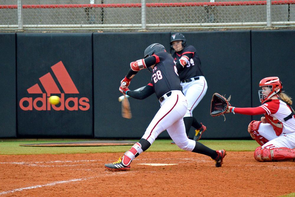 Junior utility player Brigette Nordberg swings at the ball on Sunday, Feb. 17, 2019 at Dail Softball Stadium. Nordberg had one home run and two RBIs. The Wolfpack lost 6-3 to Wisconsin.