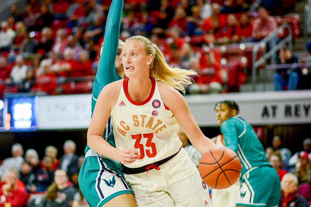 Sophomore center Elissa Cunane dribbles past a UNCW player at Reynolds Coliseum on Sunday, Nov. 10, 2019. This was head coach Wes Moore&#8217;s 700th career win as NC State beat UNCW 80-40.