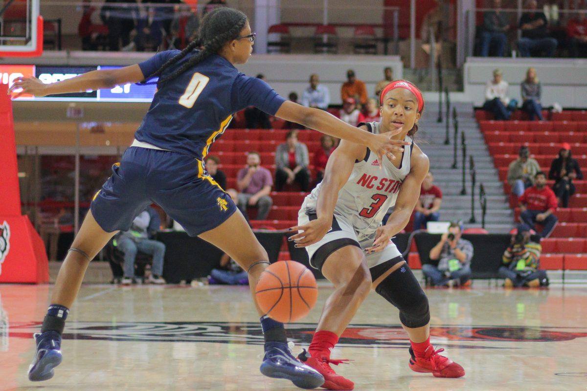 Junior guard Kai Crutchfield passes past the defense during the 80-44 win over NC A&amp;T on Wednesday, Nov. 6, 2019 in Reynolds Coliseum.