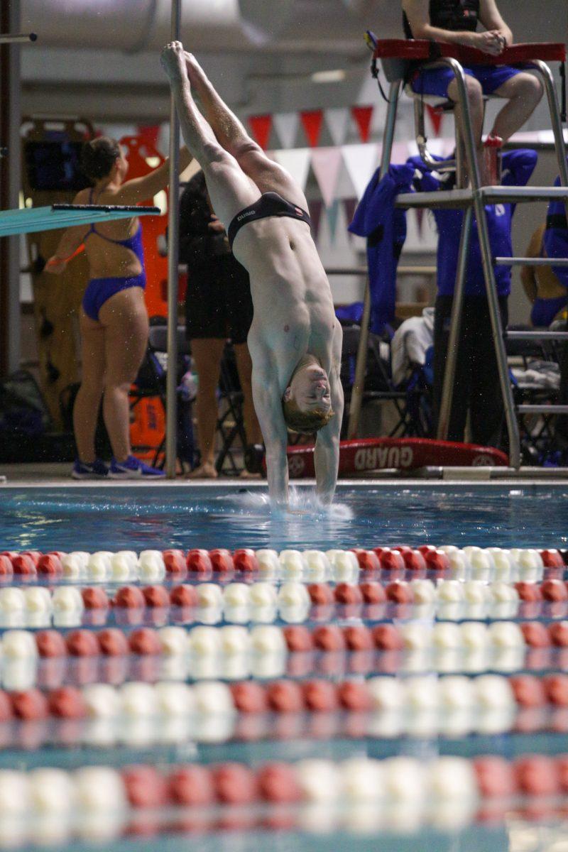 Freshman Bayne Bennett hits the water on the dive off of the 1-meter board. Bennett placed third with a 292.58. The Wolfpack would go on to defeat Duke 191-104 on Saturday, Jan. 18 in the Casey Aquatic Center.