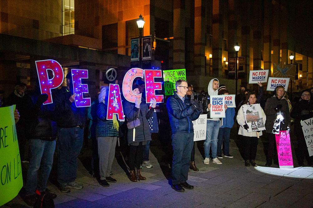 Protesters gather at Bicentennial Plaza on Thursday, January 1 to protest against the idea of war with Iran. Citizens held handmade signs up while listening to speakers talk about recent events taken place in the Middle East.