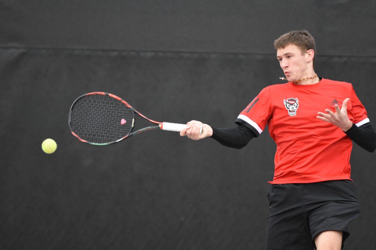 Sophomore Tadas Babelis, playing second seed in singles against South Carolina, returns the ball at the J.W. Isenhour Tennis Center on Saturday, Feb. 9. The men's tennis team lost their match against the Gamecocks 6-1, returning later in the day to beat the North Carolina A&amp;T Aggies 7-0.