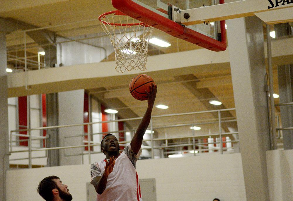 Third year Cam Wimbish, a player on the club basketball team, jumps into the air to make a layup during practice in Carmichael Gym on Wednesday, Sept. 18, 2019.