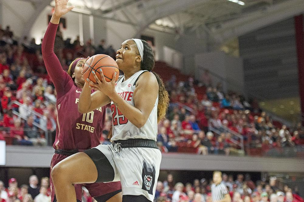Junior forward Kayla Jones goes up for a layup against a Florida State defender at Reynolds Coliseum on Thursday, Jan. 16, 2020. The Wolfpack beat the Seminoles 68-51.