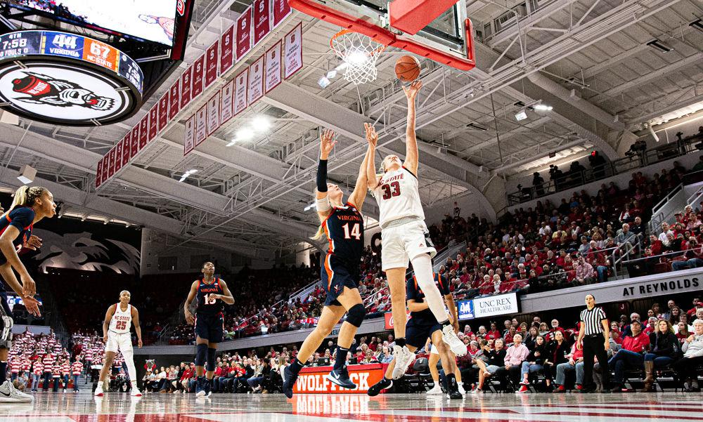 Sophomore center Elissa Cunane attacks the basket against Virginia forward Lisa Jablonowski on Sunday, Jan. 5 at Reynolds Coliseum. Cunane scored a game-high 26 points as the Wolfpack won 80-60.