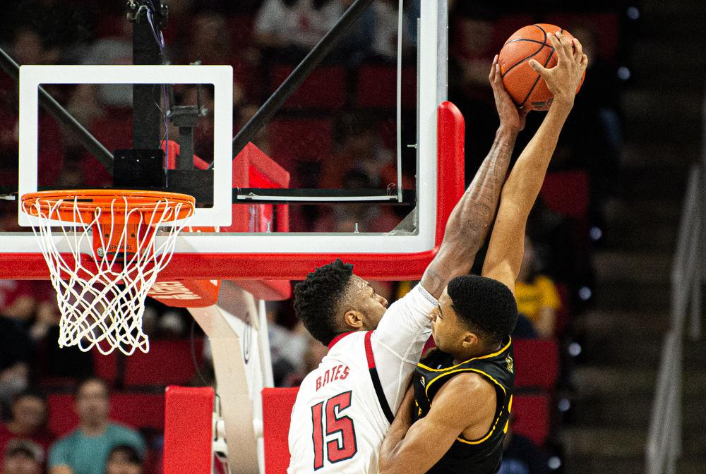 Redshirt freshman forward Manny Bates blocks a shot by Appalachian State forward Kendall Lewis on Sunday, Dec. 29, 2019 at PNC Arena. Bates recorded six points, nine rebounds and five blocks as the Wolfpack won 72-60.