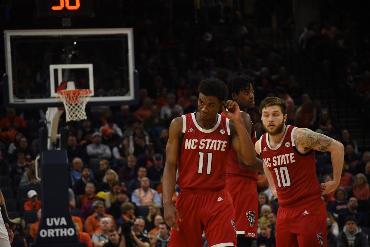 Senior guard Markell Johnson, junior guard Braxton Beverly and redshirt junior forward DJ Funderburk wait during the Wolfpack's win over Virginia. The Wolfpack went through a long scoreless stretch during the second half.