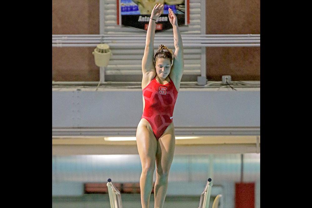 Junior diver Madeline Kline takes to the air in the diving circus during the fourth annual Wolfpack Games held on Friday, Sept. 28, 2018 in the Casey Aquatic Center.