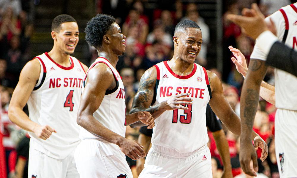 Redshirt senior guard C.J. Bryce smiles heading into a timeout against Miami on Wednesday, Jan. 15, 2020 at PNC Arena. Bryce recorded six points and five assists in his first game back from injury as the Wolfpack won 80-63.