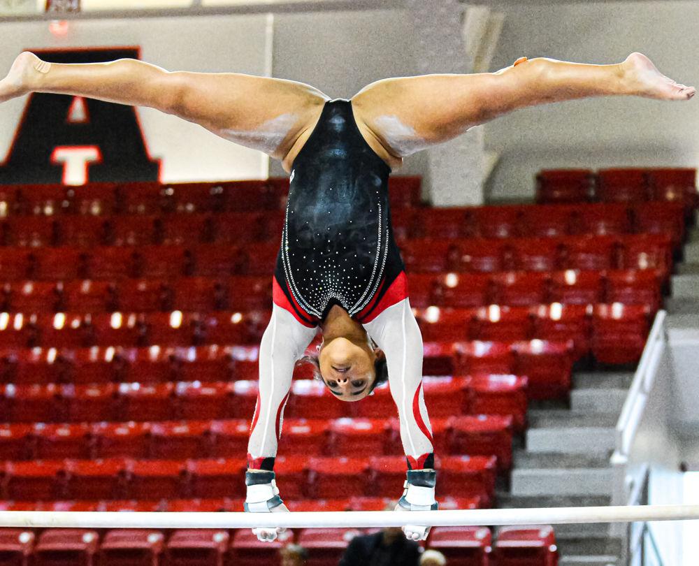 Senior Drew Grantham performs her bars routine during the Red &amp; White Exhibition on Saturday, Dec. 21, 2019 at Reynolds Coliseum. Grantham studies communication and is from Durham.