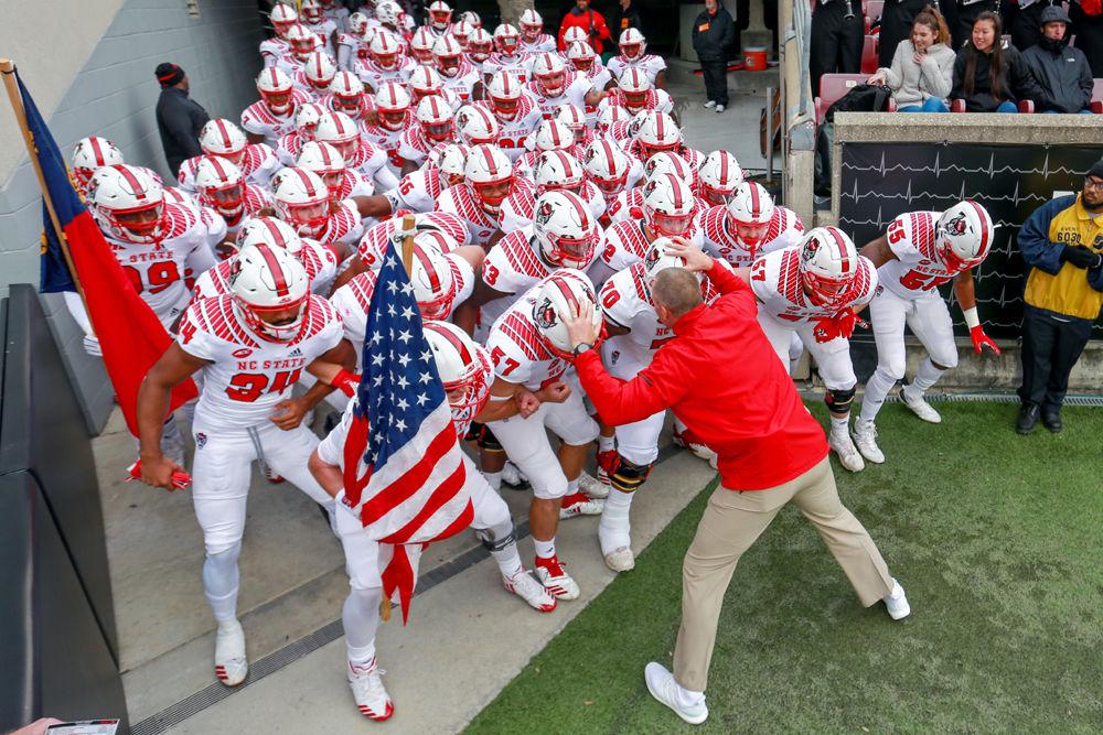 Head coach Dave Doeren gets the team hyped up before taking the field against Louisville on Saturday, Nov. 17, 2018 in Cardinal Stadium. The Wolfpack dominated Louisville 52-10.