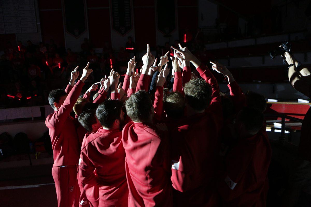 The men's swimming and diving team huddle before the meet. The men took down Duke 191-104 in the Casey Aquatic Center on Saturday, Jan. 18.