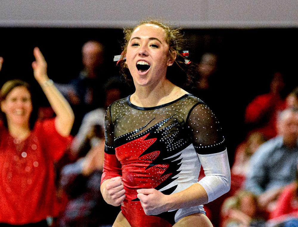 Alexis Beucler celebrates after her beam routine during the Red &amp; White Exhibition on Saturday, Dec. 21, 2019 at Reynolds Coliseum. Beucler is a senior in exploratory studies and is from Findlay, Ohio.