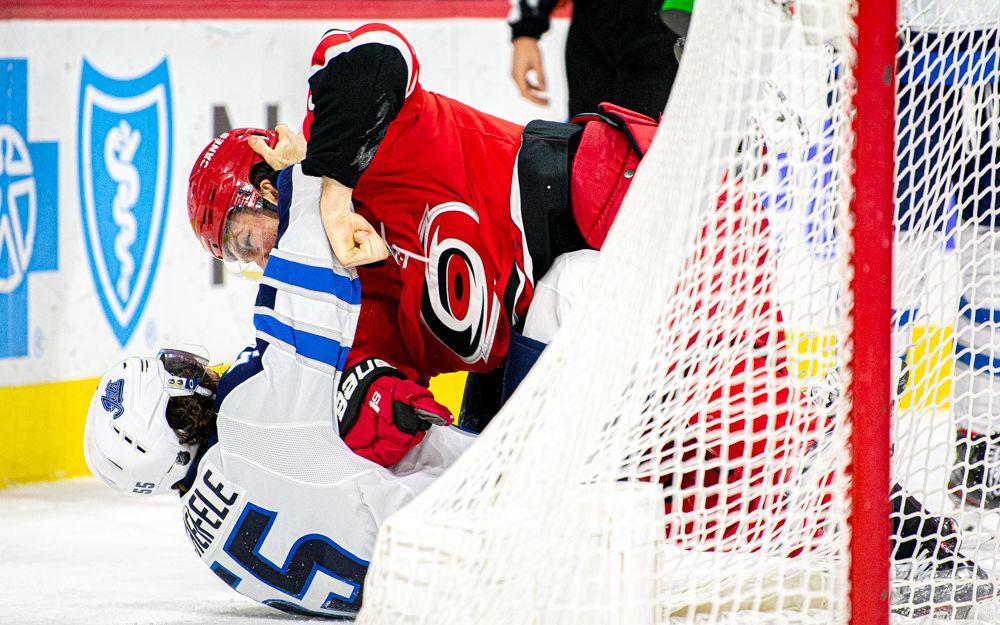 Carolina Hurricanes defenseman Brett Pesce fights Winnipeg Jets center Mark Scheifele on Tuesday, Jan. 21 at PNC Arena. Scheifele assisted on Winnipeg&#8217;s only goal as they lost to Carolina 4-1.