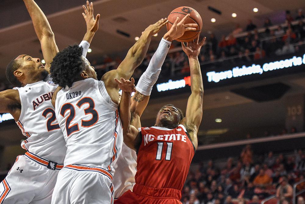 Senior guard Markell Johnson attempts to keep control of the ball against three Auburn defenders on Thursday, Dec. 19, 2019 at Auburn Arena in Alabama. Johnson went 6-11 from the field and totaled 17 points in the 79-73 loss to the Tigers.