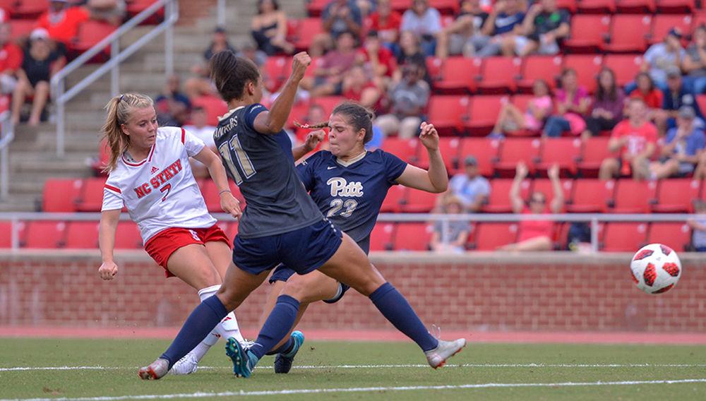 Junior midfielder Ricci Walkling shoots between the Pittsburgh defense and scores on Sunday, Sept. 23, 2018 in Dail Soccer Stadium. Walkling scored twice against the Panthers and had one assist. The Wolfpack beat the Panthers 6-0.