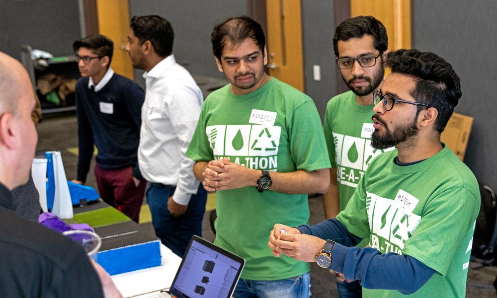 Kshitij Hasamnis, a graduate student in mechanical engineering, Adhiraj Shinde, a graduate student in textile engineering and Hitesh Manglani, a graduate student in textile engineering, pitch their design to a group of judges at the 2019 Make-A-Thon in Hunt Library on Sunday, Feb. 3, 2019. Make-A-Thon is a competition where teams have 48 hours to plan, design and build a product that addresses an environmental challenge. A panel of judges then evaluates each team and selects a winner.