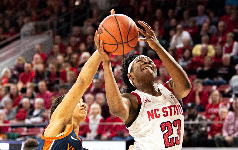 Redshirt senior guard Grace Hunter shoots against Virginia guard Carole Miller on Sunday, Jan. 5 at Reynolds Coliseum. Hunter scored 10 points as the Wolfpack won 80-60.