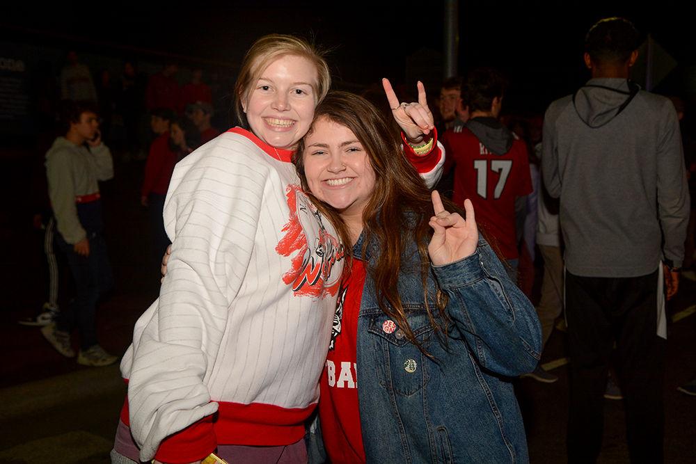 AnnaGrey Lassiter, a senior in architecture, and Jenna Lucey, a sophomore in graphic design, smile as they rush the Bell Tower after the 88-66 win over Duke on Wednesday, Feb. 19, 2020. Hillsborough Street flooded with Wolfpack fans in support of the men&#8217;s basketball team win.